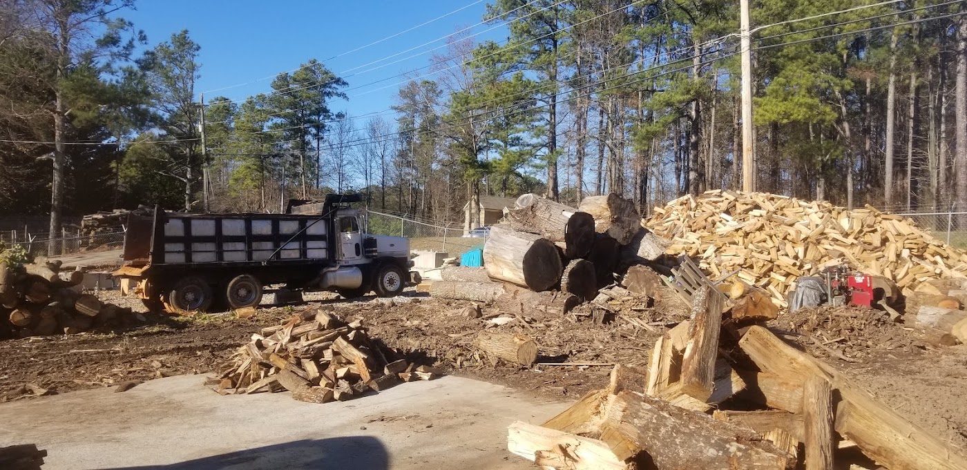 Dane yard with dump truck and split wood